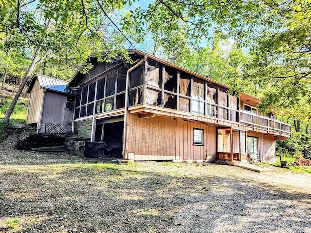 back of property featuring a sunroom