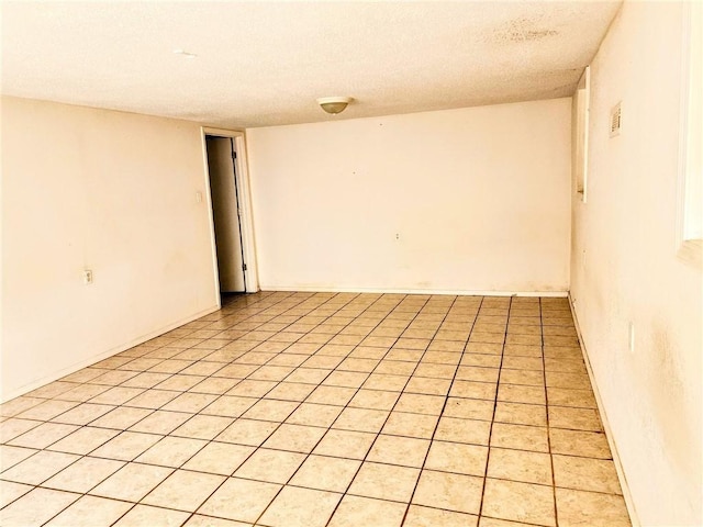 spare room featuring a textured ceiling and visible vents