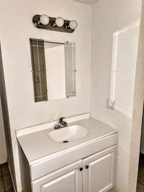 bathroom featuring tile patterned flooring and vanity