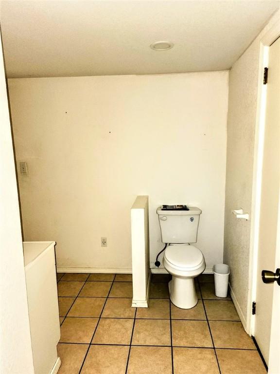bathroom featuring tile patterned flooring and toilet