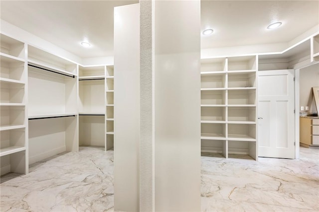 spacious closet featuring marble finish floor