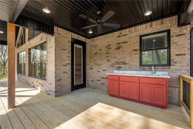 wooden terrace with a sink and ceiling fan