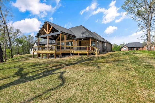 back of house featuring a wooden deck and a yard
