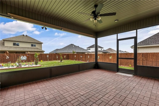 2109 Abbott Ln, Pea Ridge, AR 72751 - unfurnished sunroom with ceiling fan and brick patterned floors