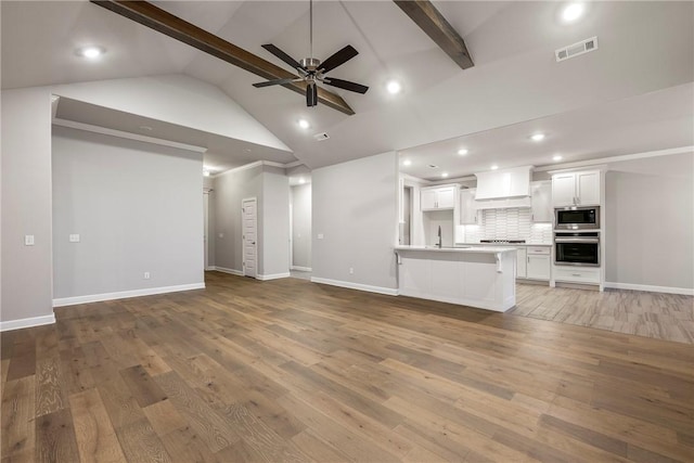 2109 Abbott Ln, Pea Ridge, AR 72751 - unfurnished living room with a sink, a ceiling fan, beam ceiling, baseboards, and wood finished floors