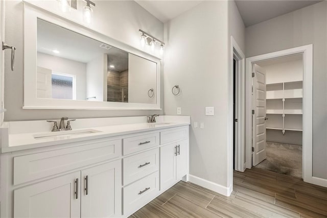 2109 Abbott Ln, Pea Ridge, AR 72751 - bathroom featuring wood finished floors, double vanity, and baseboards