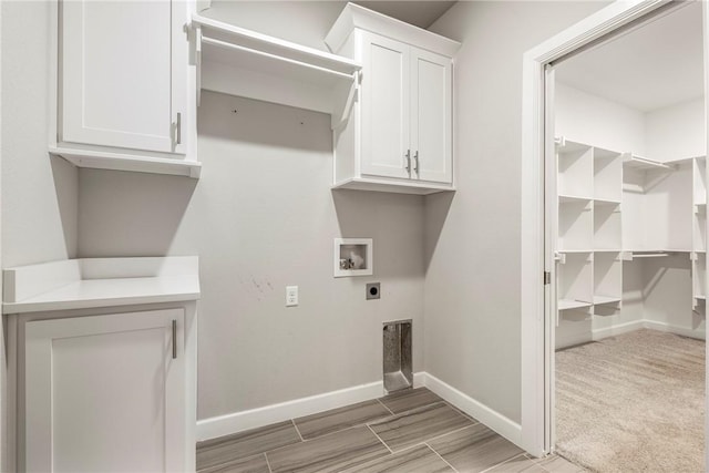 2109 Abbott Ln, Pea Ridge, AR 72751 - clothes washing area with hookup for an electric dryer, hookup for a washing machine, baseboards, and cabinet space