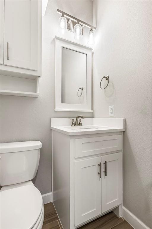 2109 Abbott Ln, Pea Ridge, AR 72751 - half bath featuring baseboards, vanity, toilet, and wood finished floors