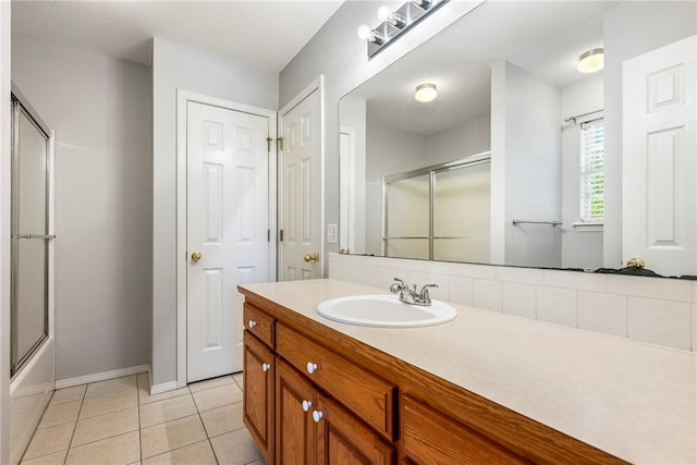 bathroom featuring baseboards, tile patterned flooring, and vanity