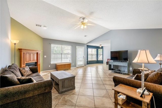 living area with visible vents, high vaulted ceiling, a textured ceiling, a ceiling fan, and light tile patterned floors