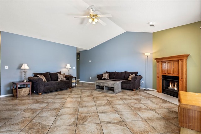 living area with ceiling fan, visible vents, baseboards, a warm lit fireplace, and lofted ceiling