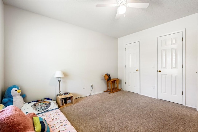 carpeted bedroom with baseboards and ceiling fan