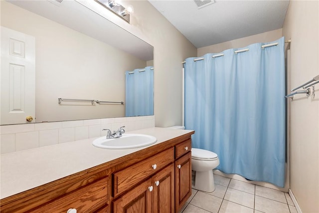 full bath featuring a shower with curtain, visible vents, tile patterned floors, vanity, and toilet