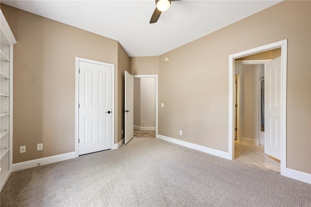 unfurnished bedroom featuring baseboards, ceiling fan, and light colored carpet
