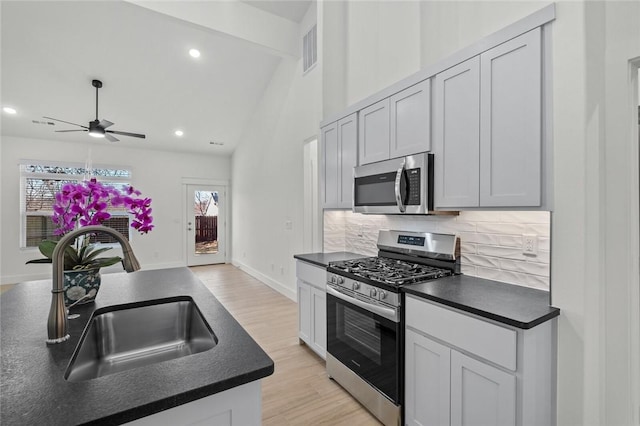 700 Sun Meadows Loop, Centerton, AR 72719 - kitchen featuring a sink, dark countertops, and stainless steel appliances