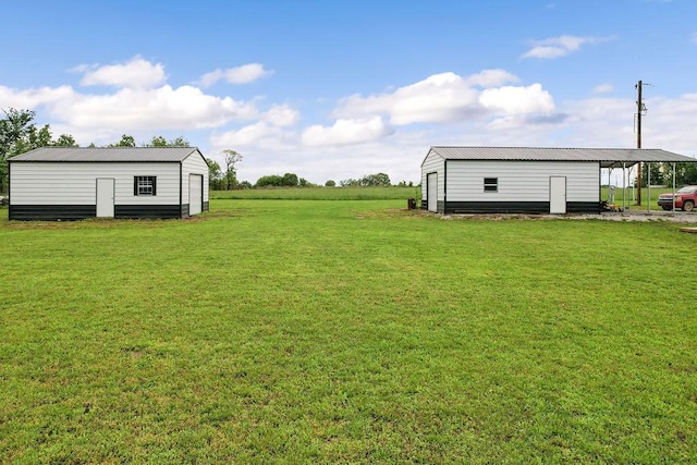 view of yard featuring an outdoor structure and a carport