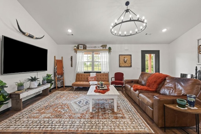 living area featuring a healthy amount of sunlight, wood finished floors, and lofted ceiling