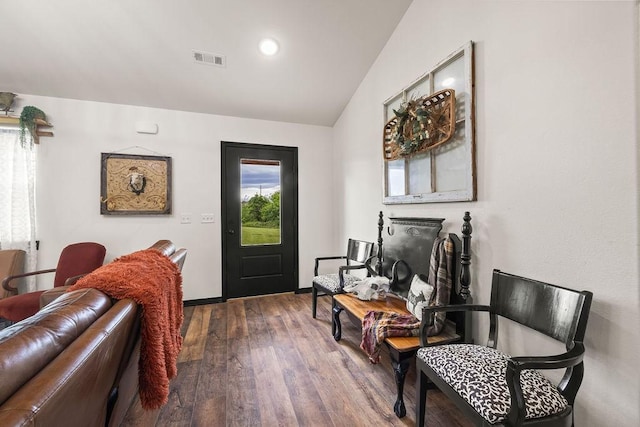living area with lofted ceiling, recessed lighting, wood finished floors, and visible vents