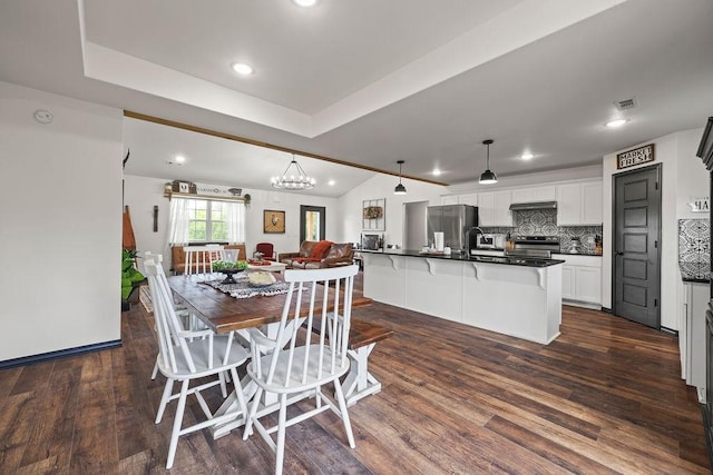 dining room featuring recessed lighting, a notable chandelier, visible vents, and dark wood-type flooring