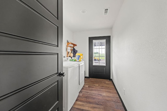 laundry room featuring laundry area, visible vents, dark wood-style flooring, baseboards, and washer and clothes dryer