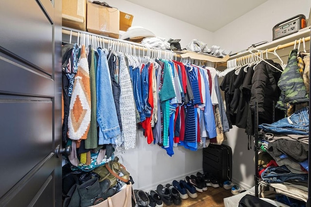 walk in closet featuring wood finished floors