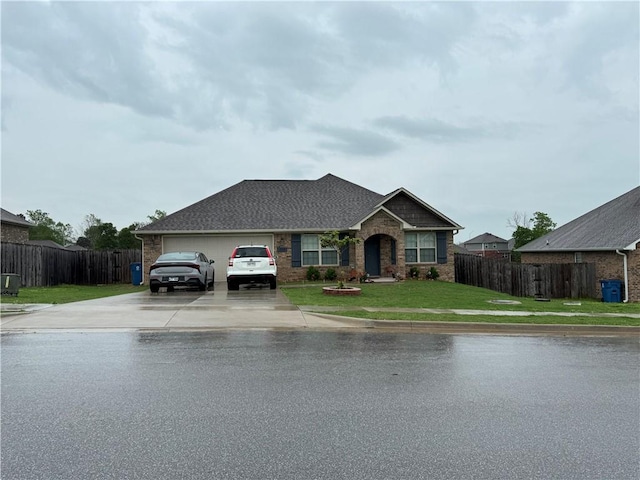 ranch-style house featuring roof with shingles, a garage, fence, a front lawn, and concrete driveway