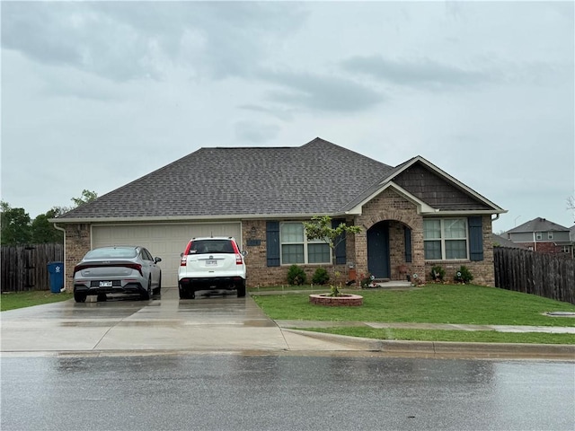 view of front of property featuring brick siding, fence, and driveway