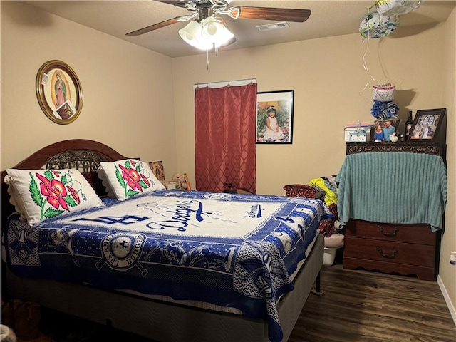 bedroom with visible vents, baseboards, ceiling fan, and wood finished floors