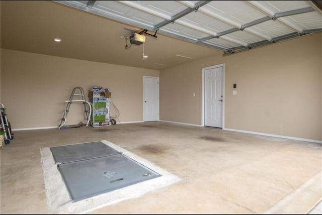 garage with baseboards and a garage door opener