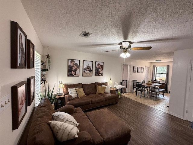 809 Walnut, Dardanelle, AR 72834 - living area featuring a textured ceiling, ceiling fan, visible vents, and wood finished floors