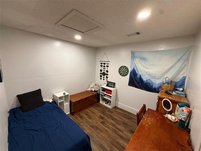 809 Walnut, Dardanelle, AR 72834 - bedroom featuring attic access, a textured ceiling, visible vents, wood finished floors, and baseboards