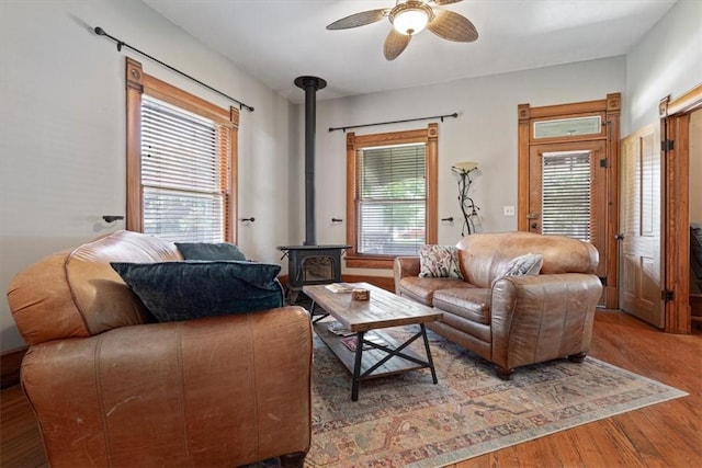605 N Wright St, Siloam Springs, AR 72761 - living room with a ceiling fan, wood finished floors, and a wood stove