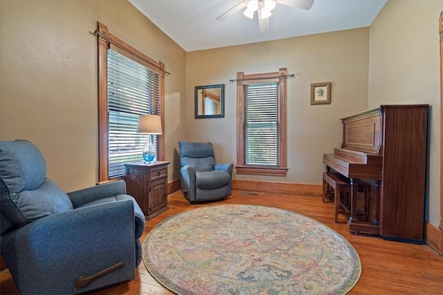 605 N Wright St, Siloam Springs, AR 72761 - living area with ceiling fan, a healthy amount of sunlight, and light wood-style floors