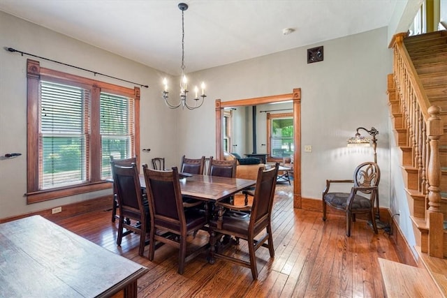 605 N Wright St, Siloam Springs, AR 72761 - dining area featuring hardwood / wood-style flooring, plenty of natural light, stairs, and a chandelier