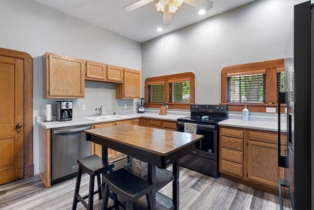 605 N Wright St, Siloam Springs, AR 72761 - kitchen with stainless steel dishwasher, a ceiling fan, black range with electric cooktop, a towering ceiling, and a sink