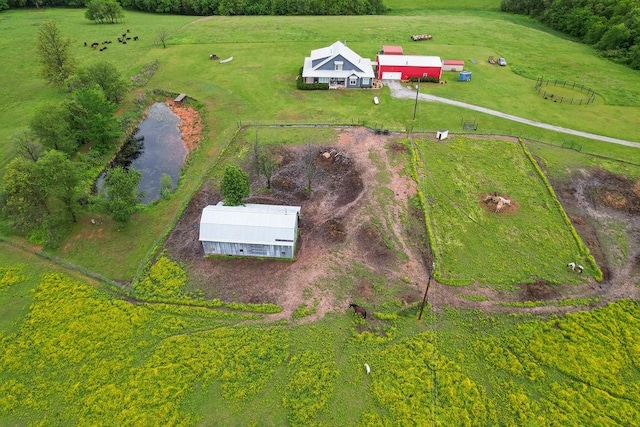 bird's eye view with a water view and a rural view