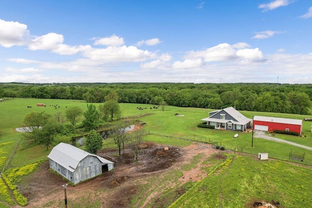 aerial view featuring a forest view and a rural view