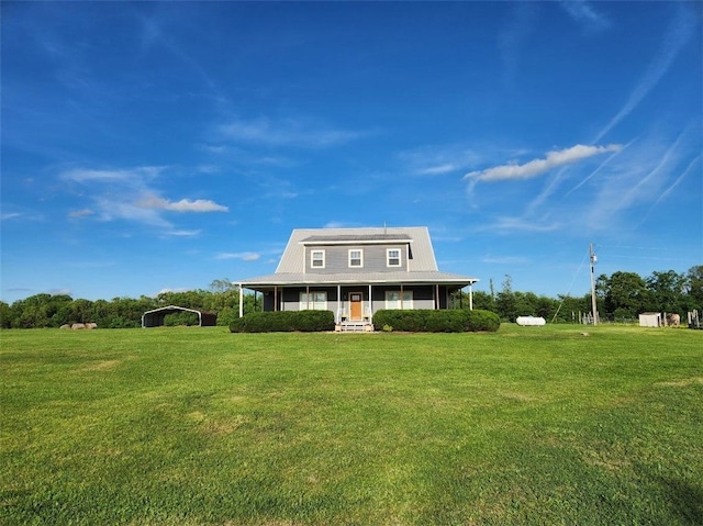 view of front of home featuring a carport, covered porch, and a front yard