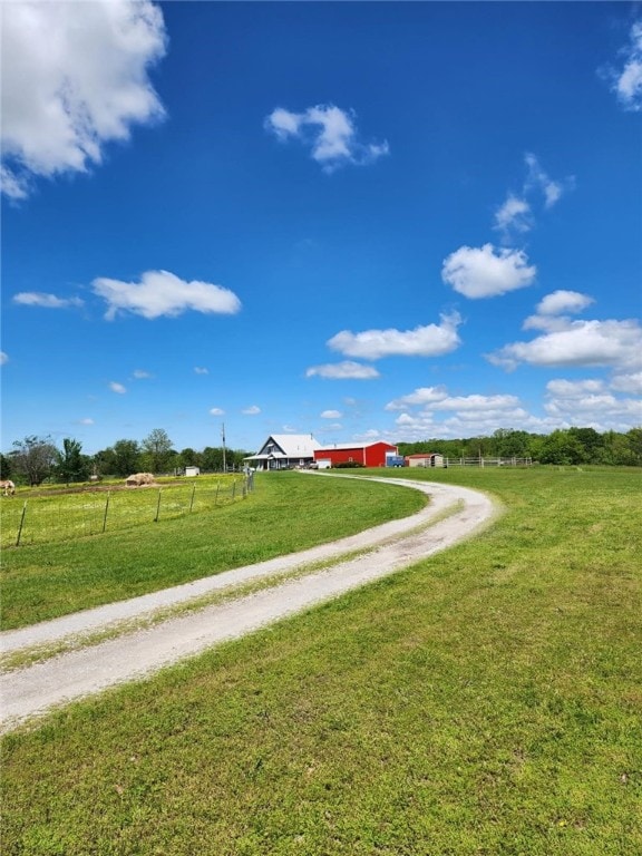 view of street with driveway and a rural view