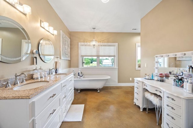 bathroom with double vanity, a sink, finished concrete flooring, and a freestanding bath