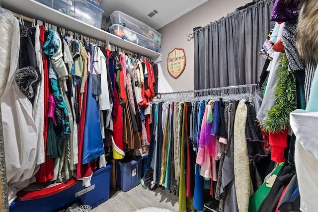 spacious closet featuring visible vents and wood finished floors