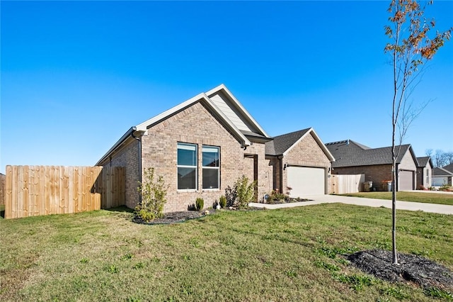 ranch-style house featuring fence, an attached garage, a front lawn, and driveway