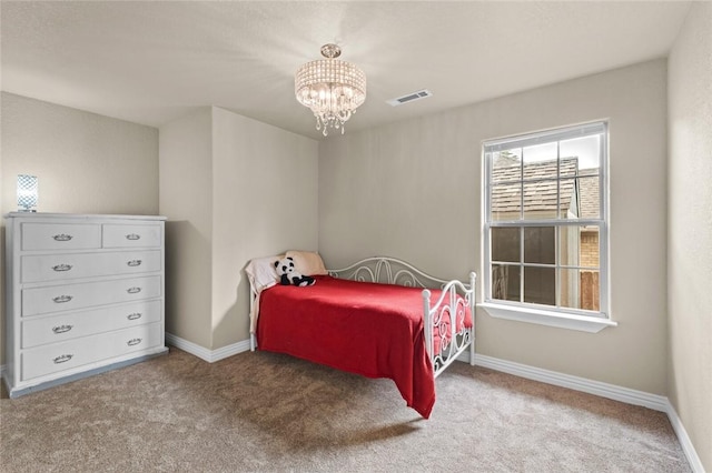 bedroom with a chandelier, carpet flooring, and baseboards