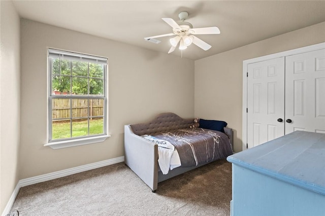 bedroom with carpet flooring, baseboards, a closet, and ceiling fan
