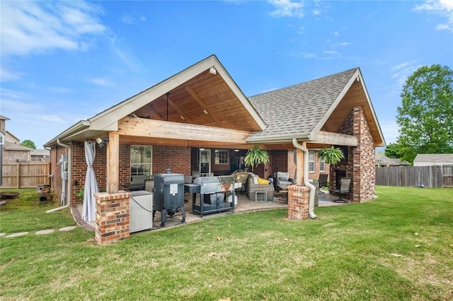 back of house with brick siding, a patio area, outdoor lounge area, and roof with shingles