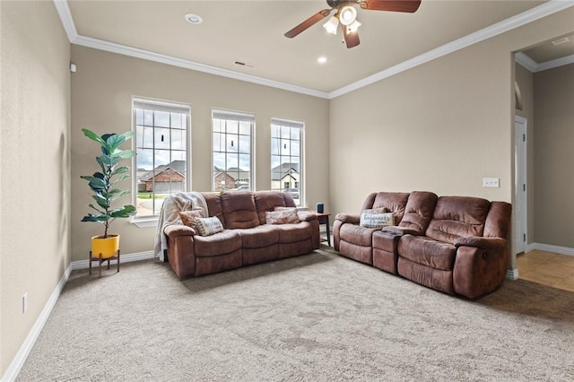 living room with carpet flooring, ceiling fan, crown molding, and baseboards