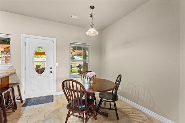 dining space featuring baseboards and light tile patterned floors