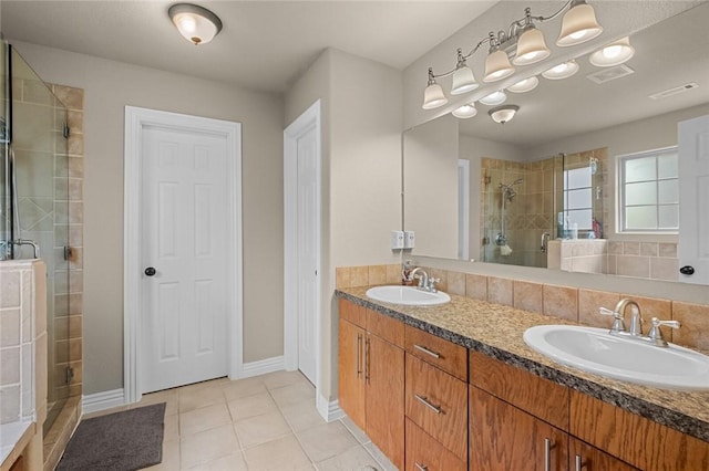 full bathroom featuring a stall shower, tile patterned floors, double vanity, and baseboards