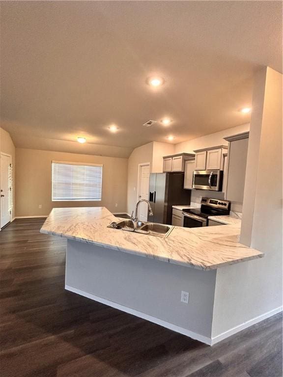 2007 Fennec St, Siloam Springs, AR 72761 - kitchen featuring light stone countertops, baseboards, dark wood-style flooring, a sink, and appliances with stainless steel finishes