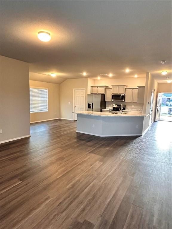2007 Fennec St, Siloam Springs, AR 72761 - kitchen with stainless steel appliances, light countertops, open floor plan, dark wood-style floors, and baseboards